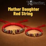 A set of two matching red string bracelets, one larger and one smaller, each with a tiny gold heart, for mother and daughter.